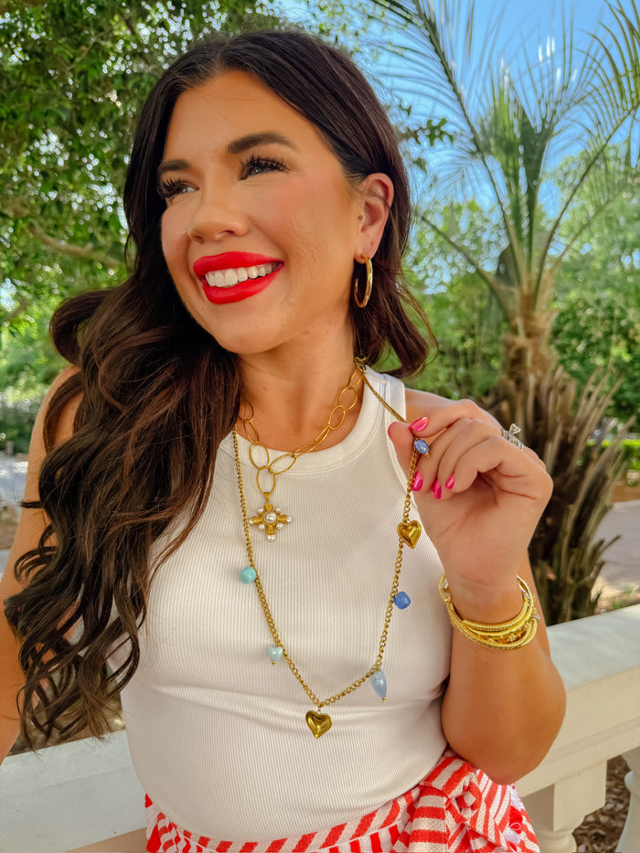 gold heart charm necklace, blue beaded necklace, dainty gold layered necklace, wholesale jewelry for women boutiques, trendy gold jewelry, statement accessory, boutique wholesale jewelry, waterproof, hypoallergenic, tarnish free